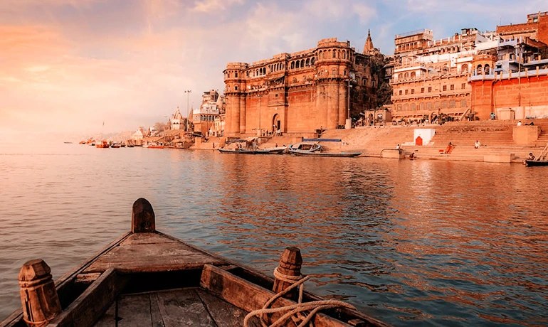 The ghats of Varanasi seen from a wooden boat at sunrise