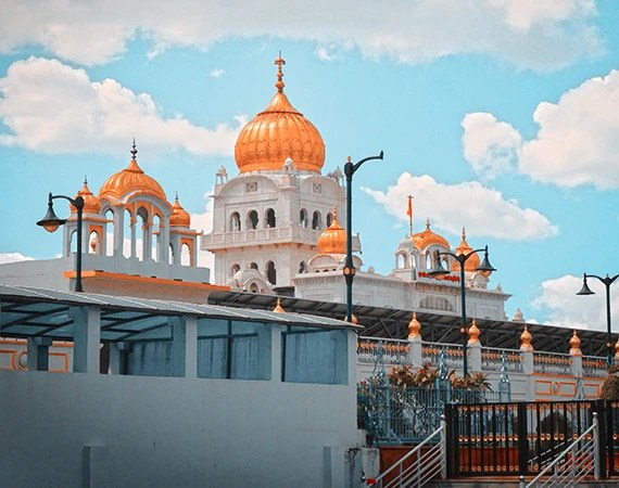 A painted dome and courtyard in bright sunlight