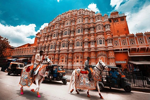 The Hawa Mahal in Jaipur with painted horses in front