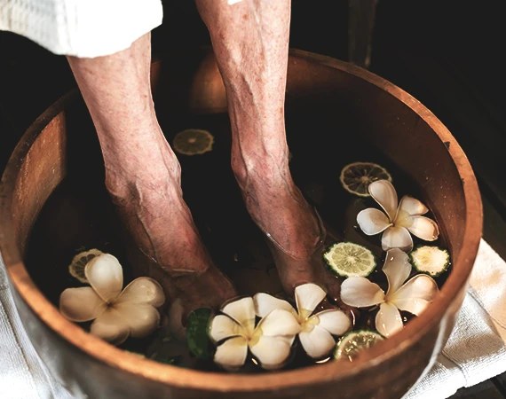 A flower foot bath in a wooden bowl