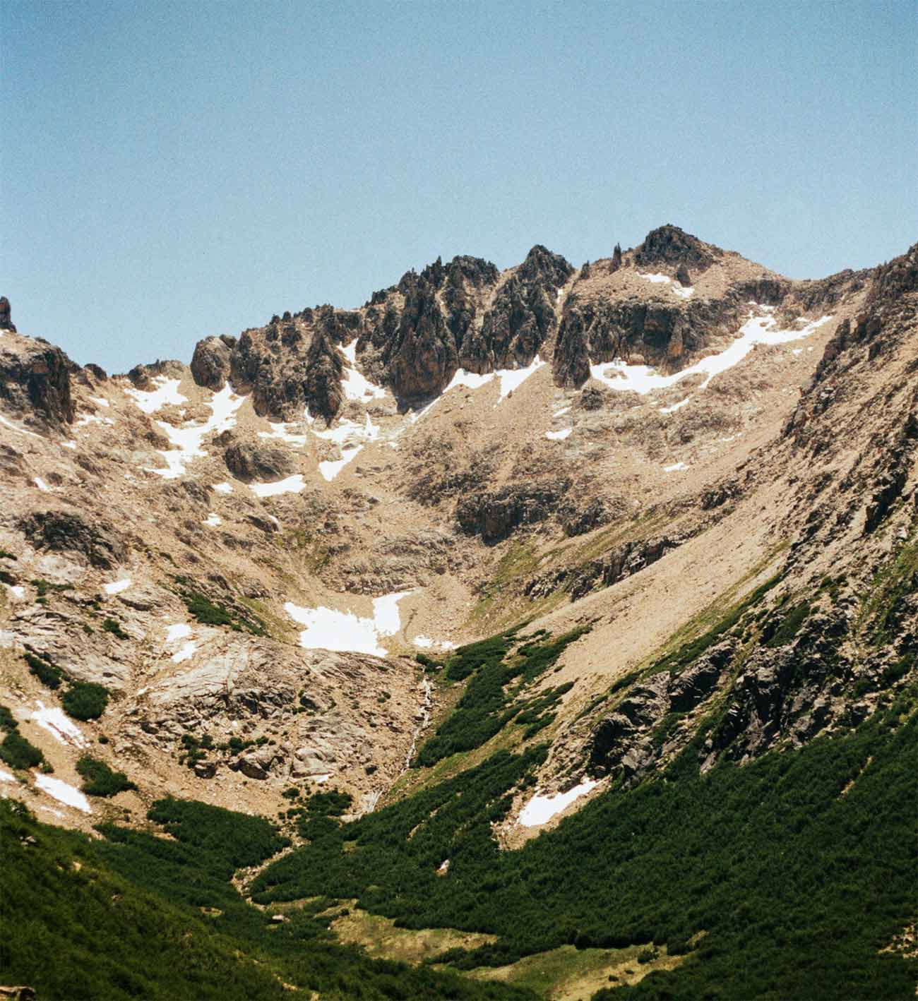 Snow-capped mountains above a green valley