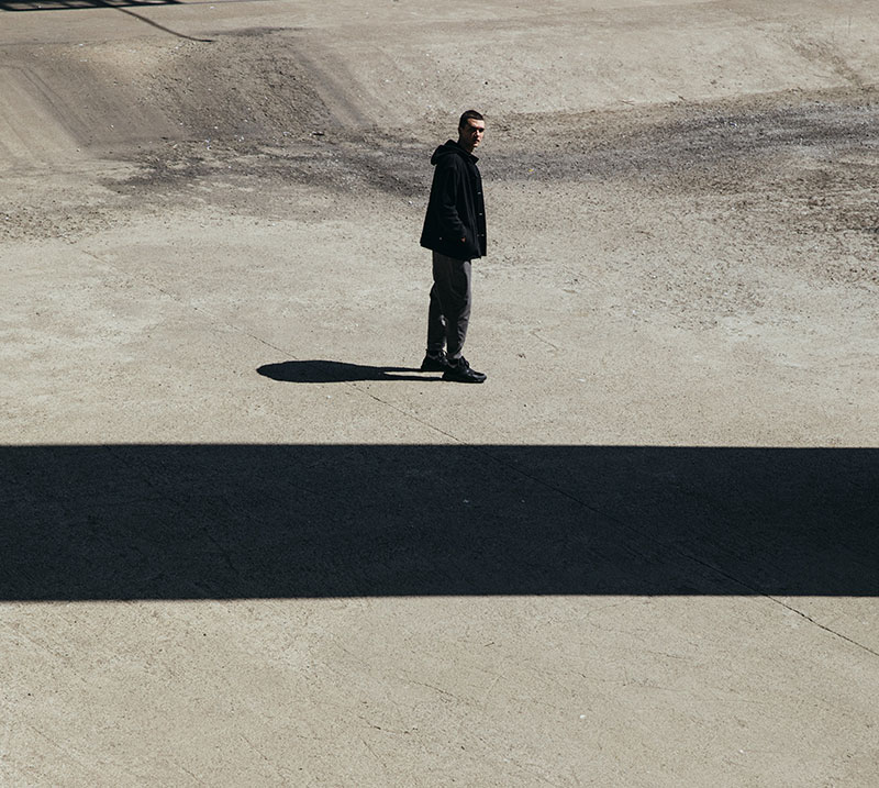 A lone walker on pale sand