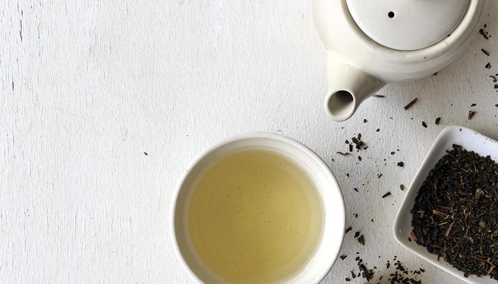A cup of black tea on a white table