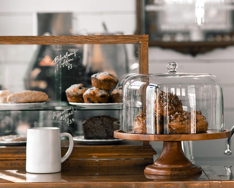 Cakes under glass domes on the counter