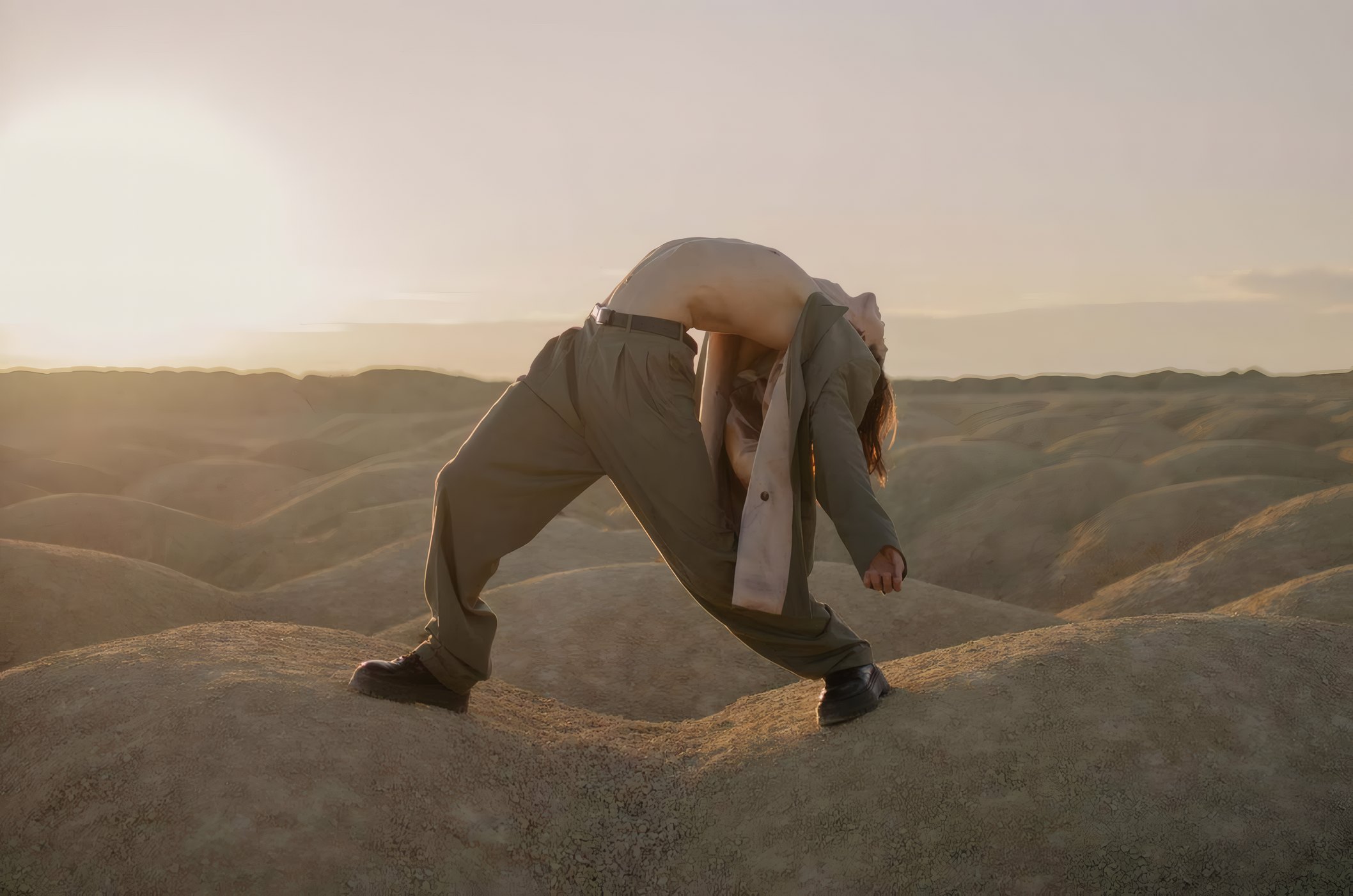 A figure bending into the wind on the dunes, from Salt Road