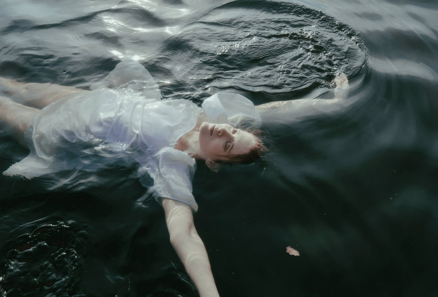 The singer drifting on dark water
