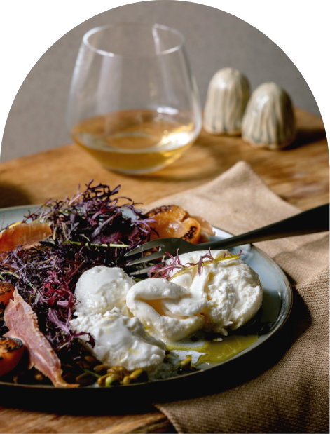 Burrata with figs and walnut, a glass of white beside it