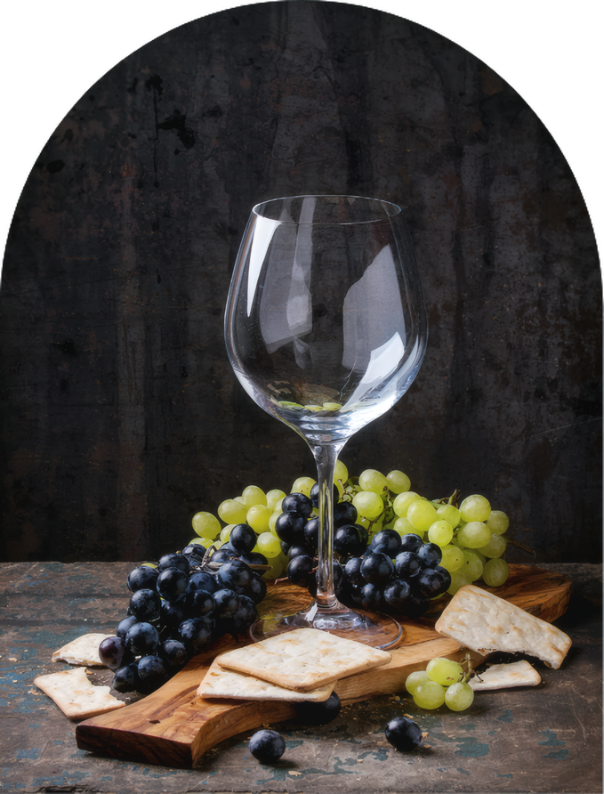 Grapes, cheese and crackers beside a glass of wine