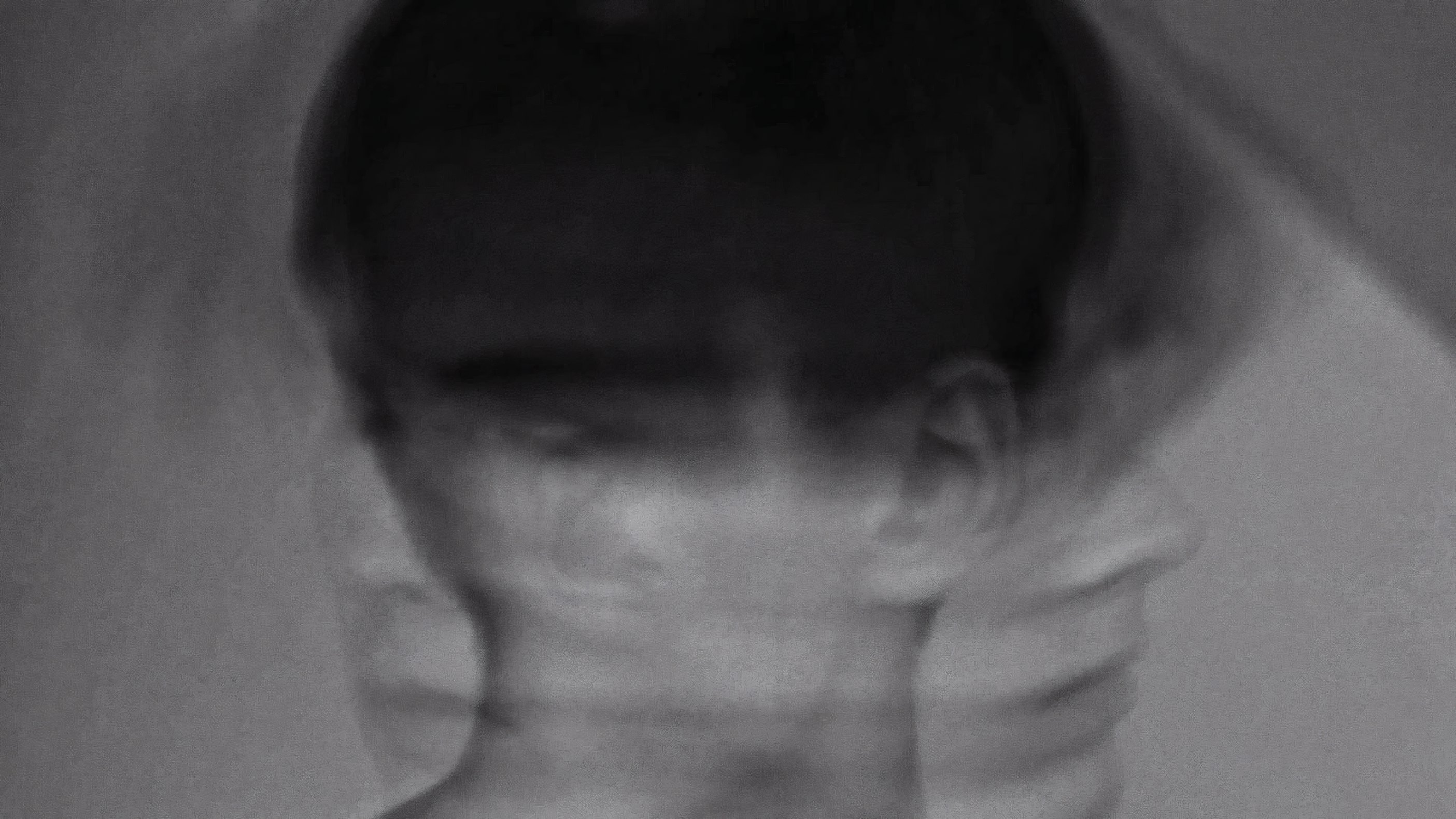 A face in motion, blurred in black and white