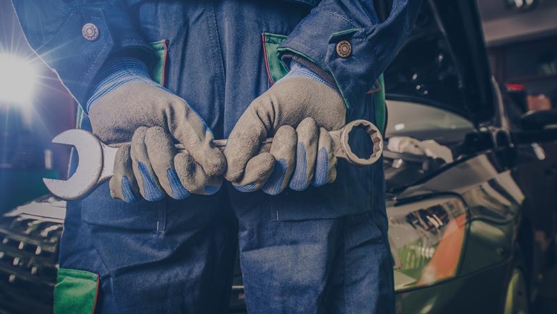 Gloved hands holding spanners