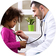 A pediatrician listening to a girl's heartbeat