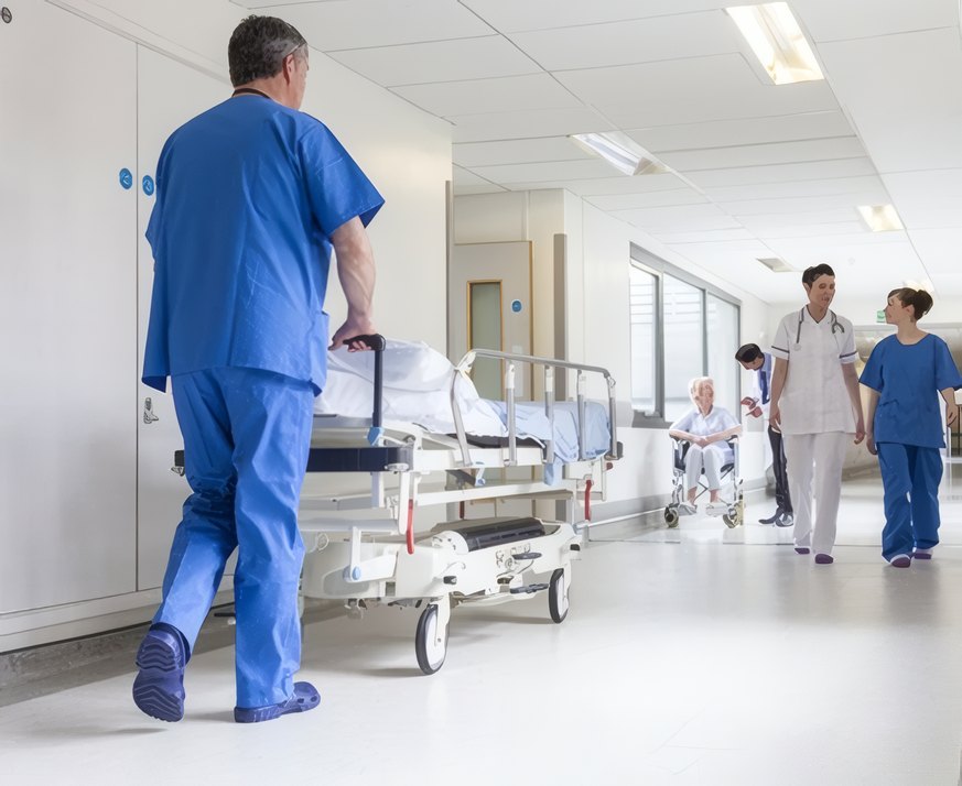 A nurse and doctor walking down the ward corridor