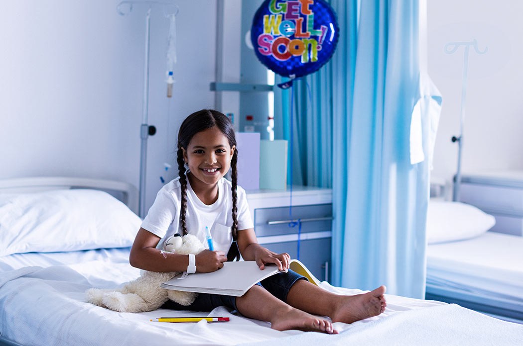 A girl reading on the children's ward