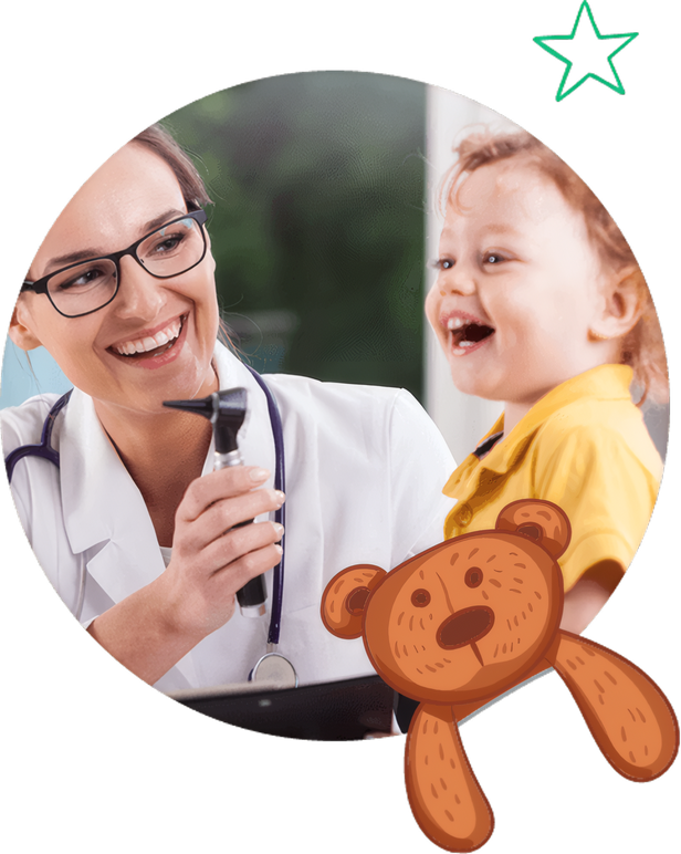 A pediatrician laughing with a toddler and his teddy bear