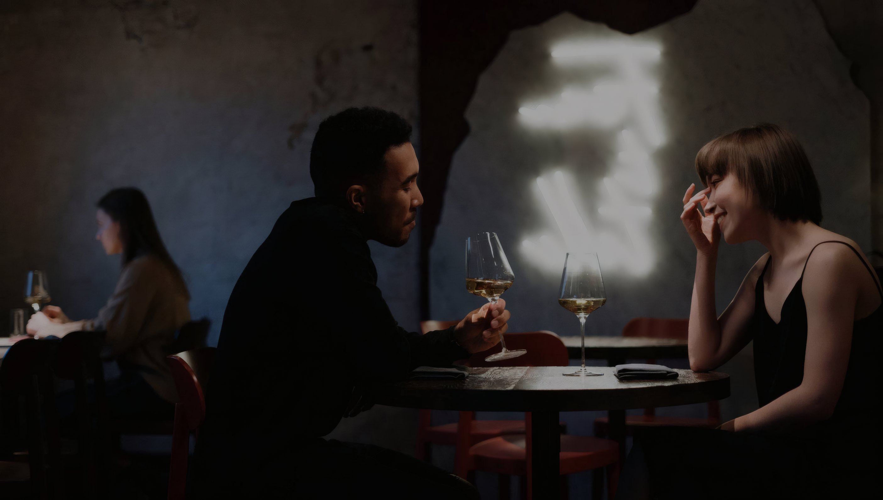 Guests at a candlelit table in Oro