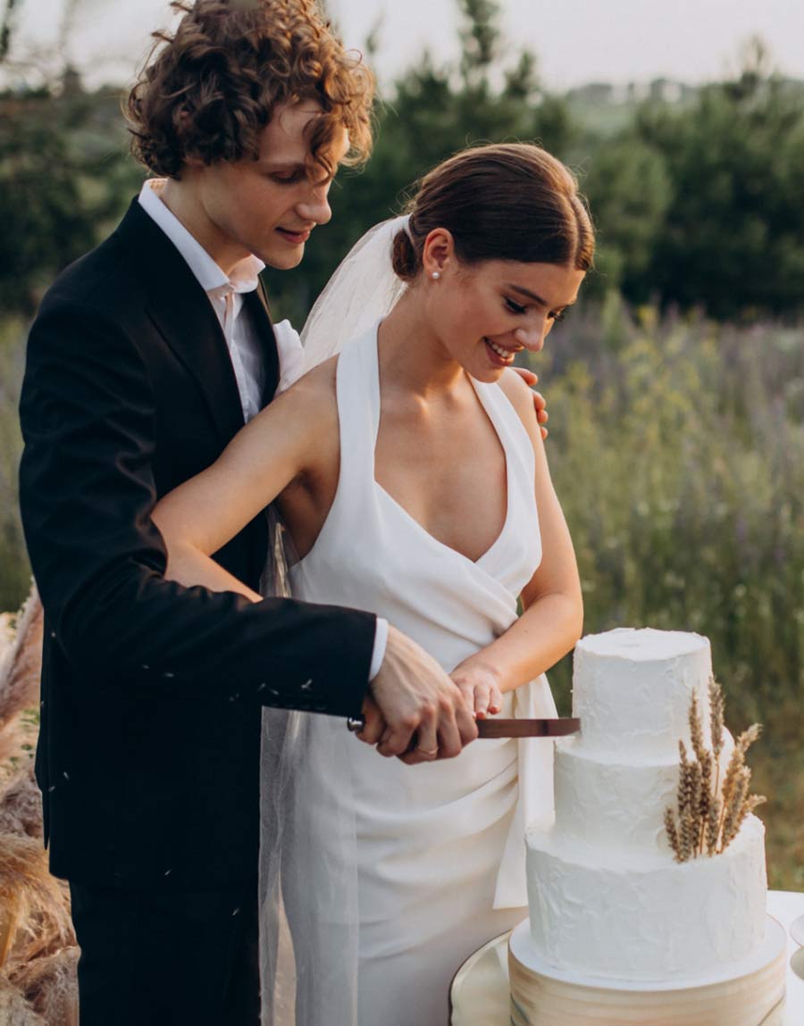 A couple cutting their wedding cake