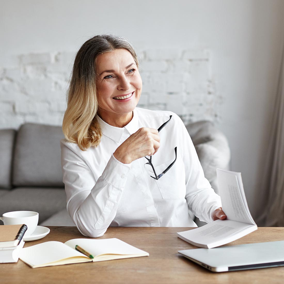 A therapist smiling at her desk between sessions