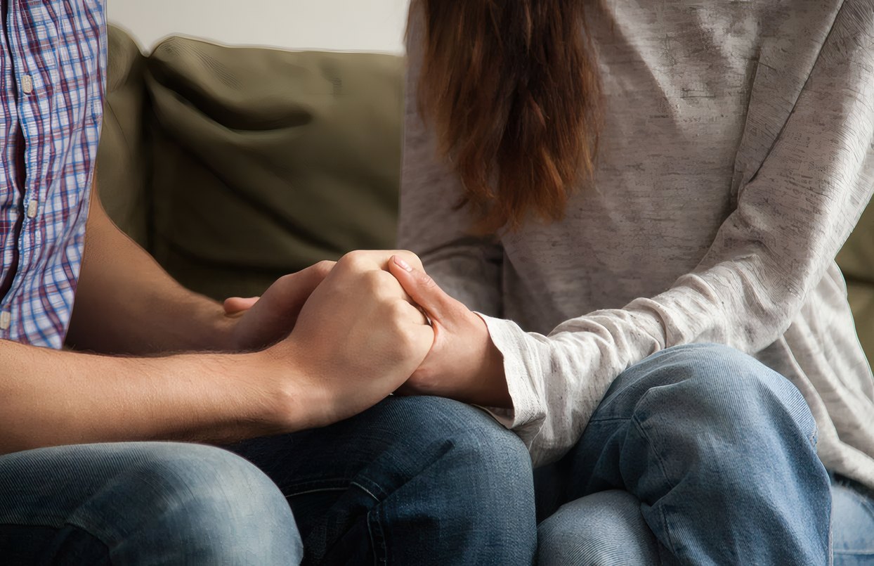 Two hands held in support