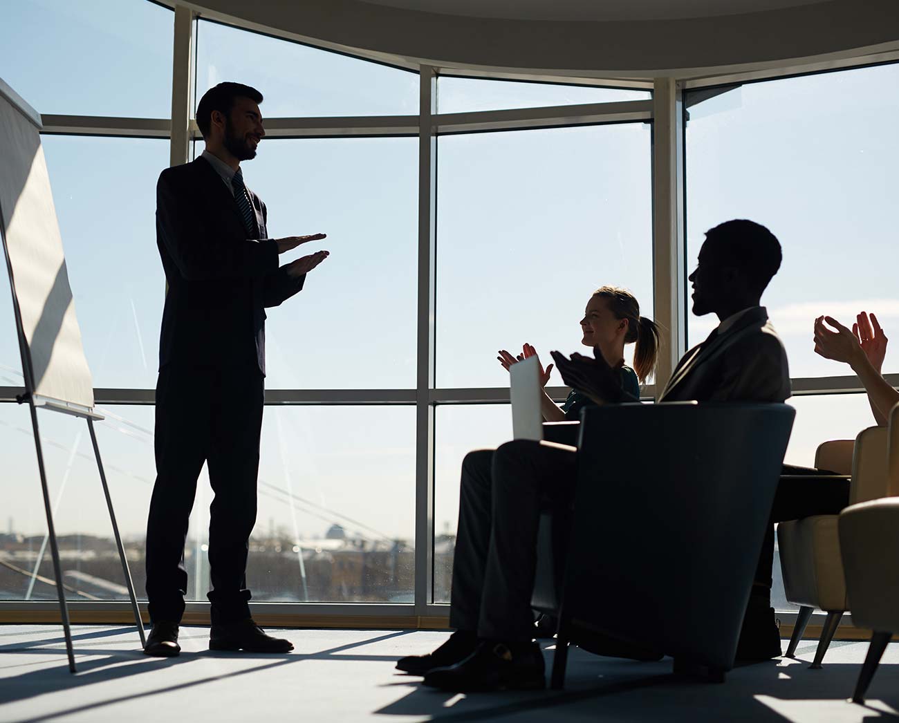 A therapist and a client talking by a tall window