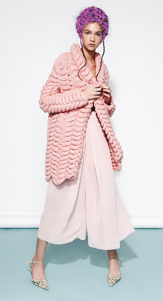 A blush cable-knit coat over wide trousers, a look from Powder Room
