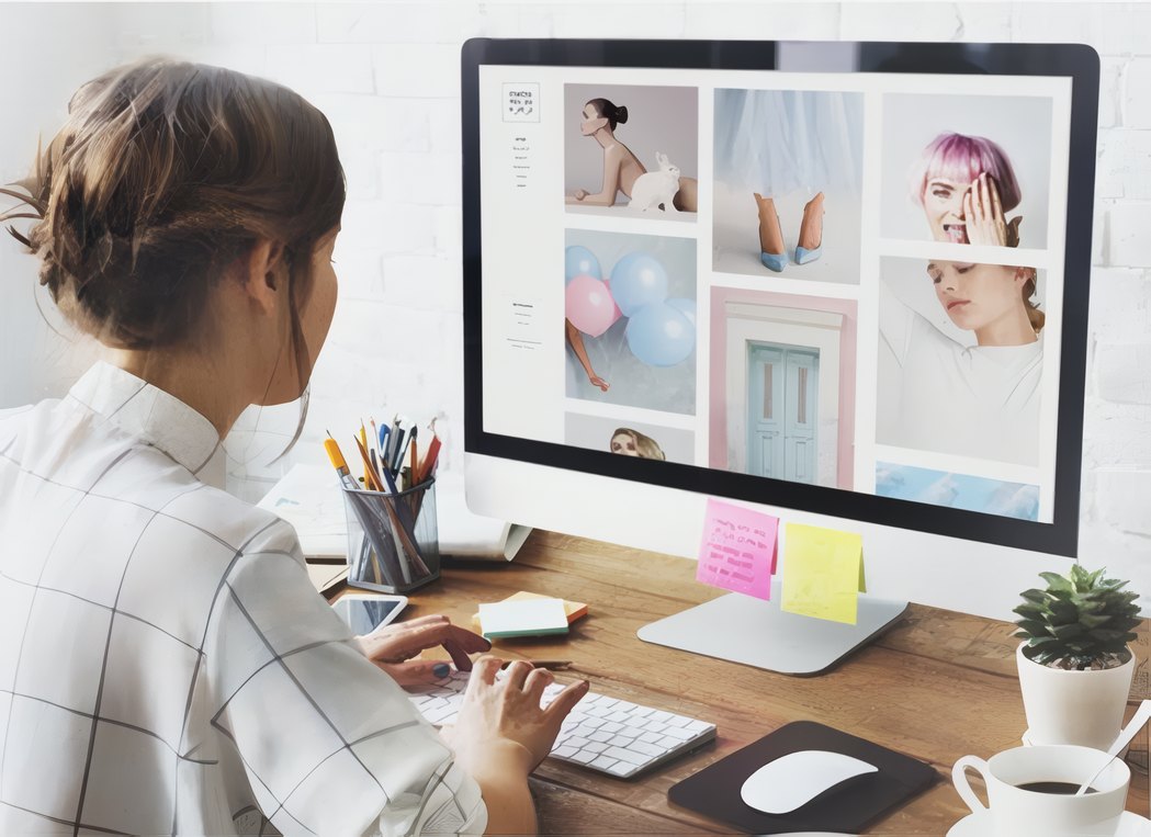 A student retouching a shoot on a large screen