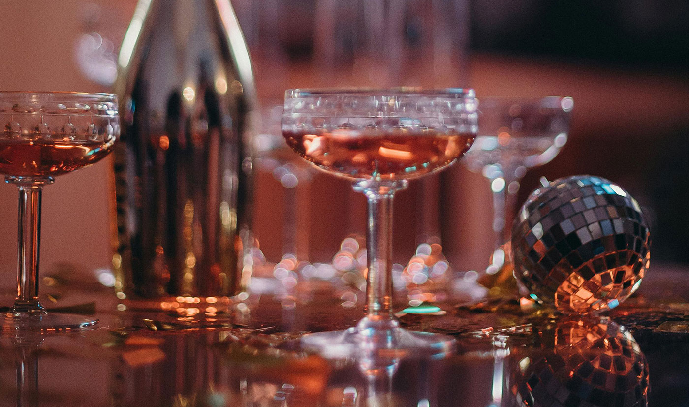 A bottle of rosé and coupes on a party table