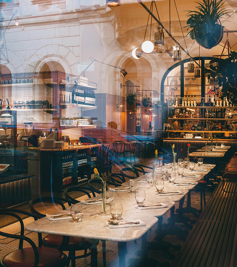 The long table of the bar in evening light