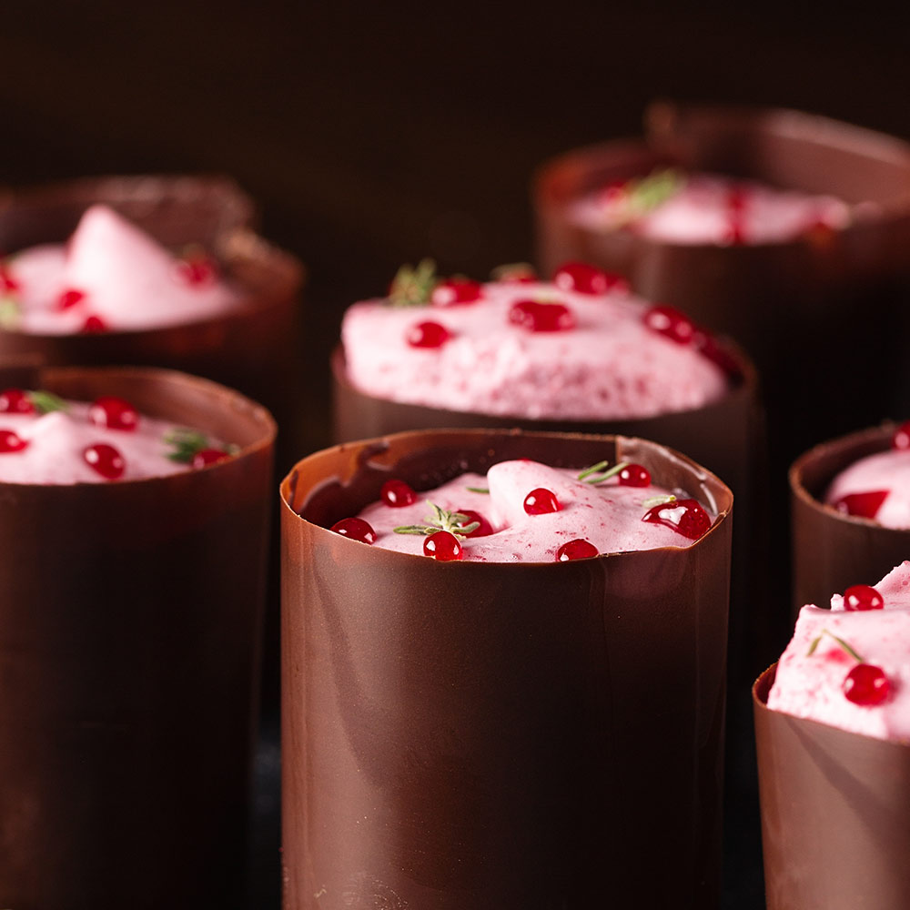 Chocolate cups filled with raspberry mousse