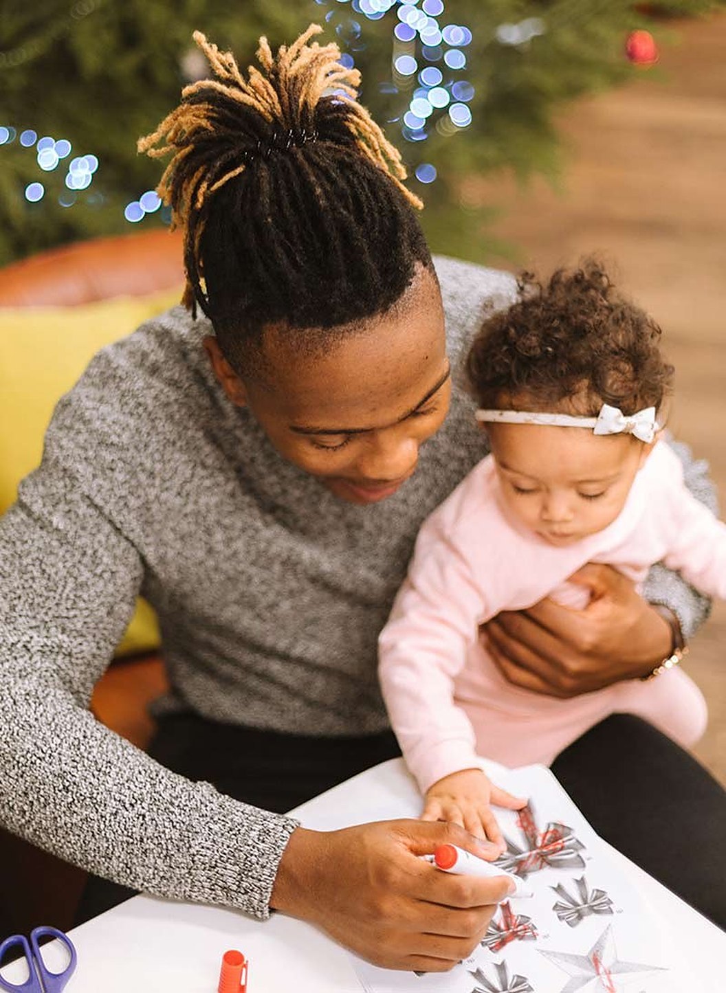 A father drawing with his baby daughter