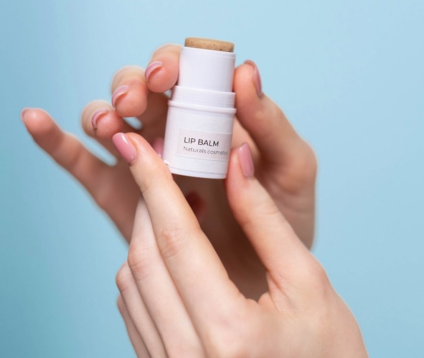 A hand holding a lip balm