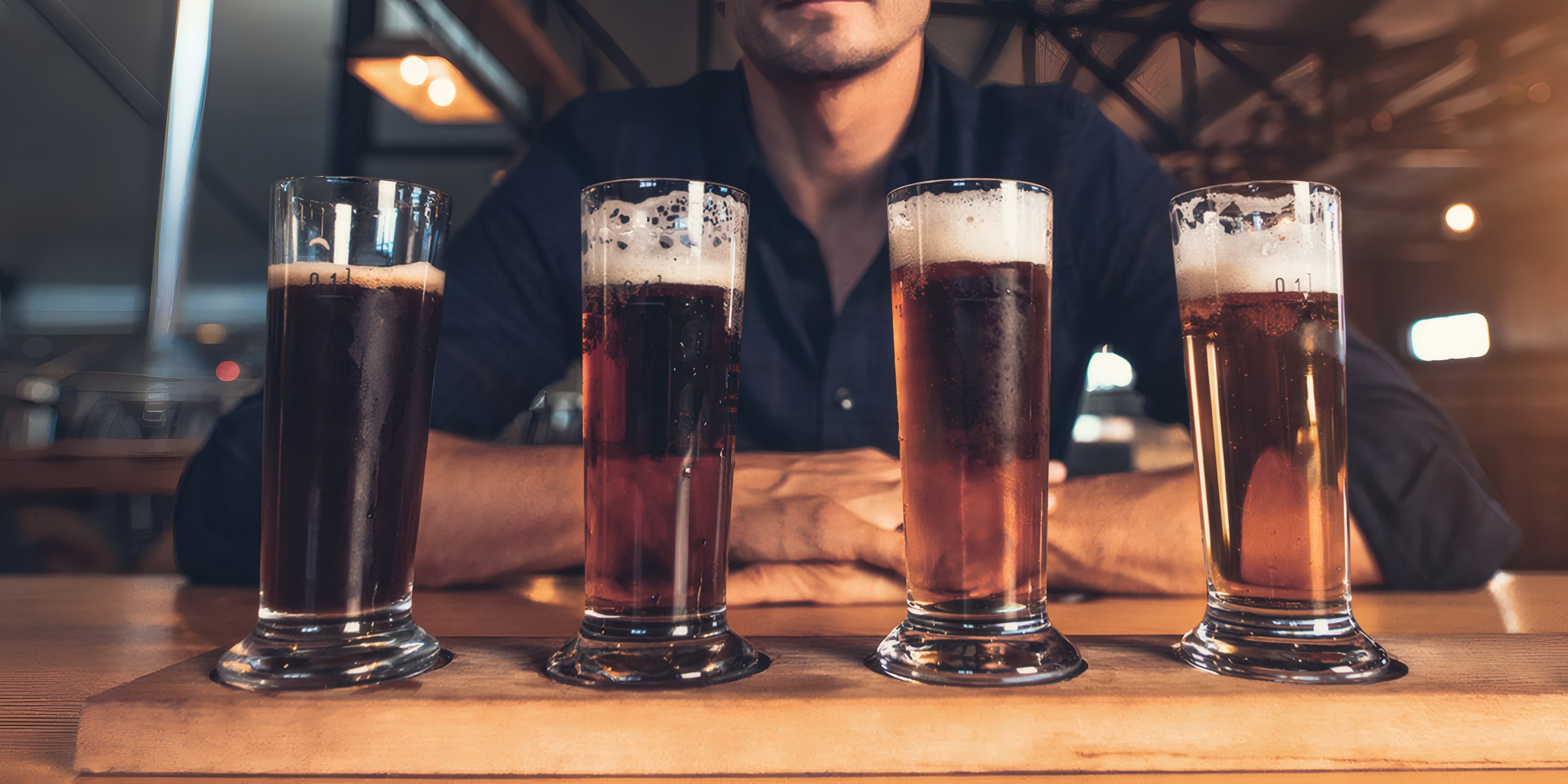 A tasting flight of four beers on the bar