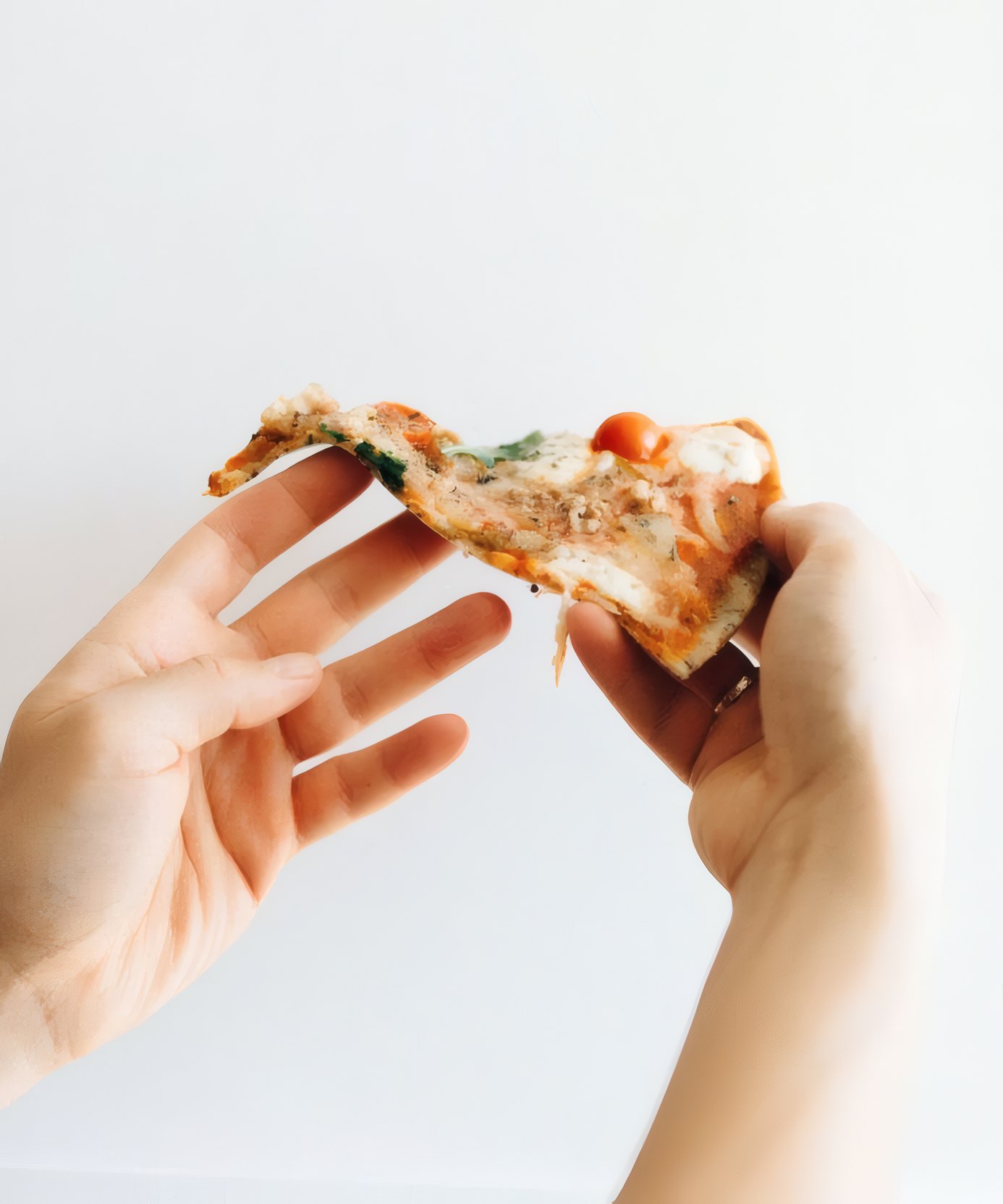 Hands holding a slice
