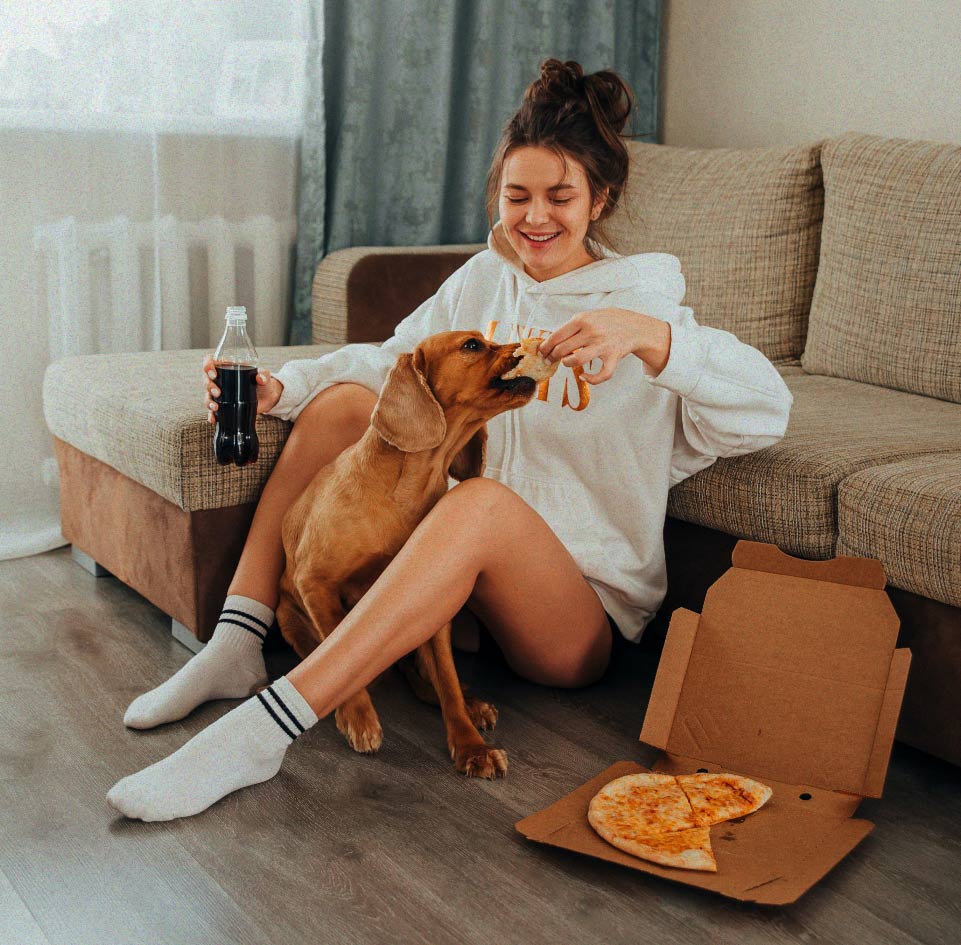 A friend with her dog and an open pizza box
