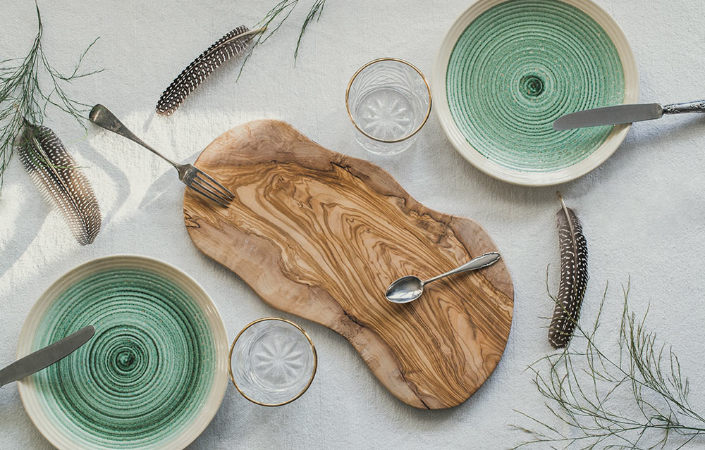 Green plates and an olive-wood board