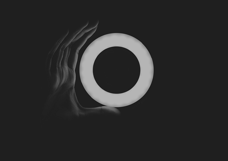 A ring light in a dark studio