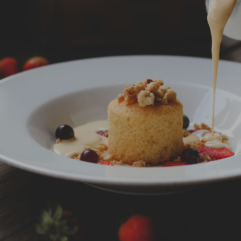 A vanilla sponge with cream poured over