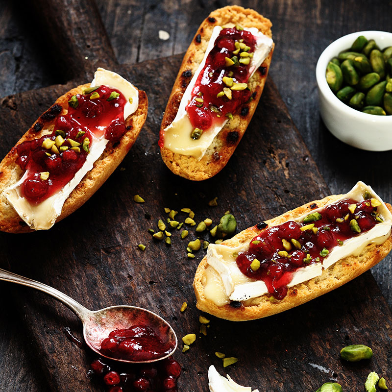 Cherry crostini on a dark board