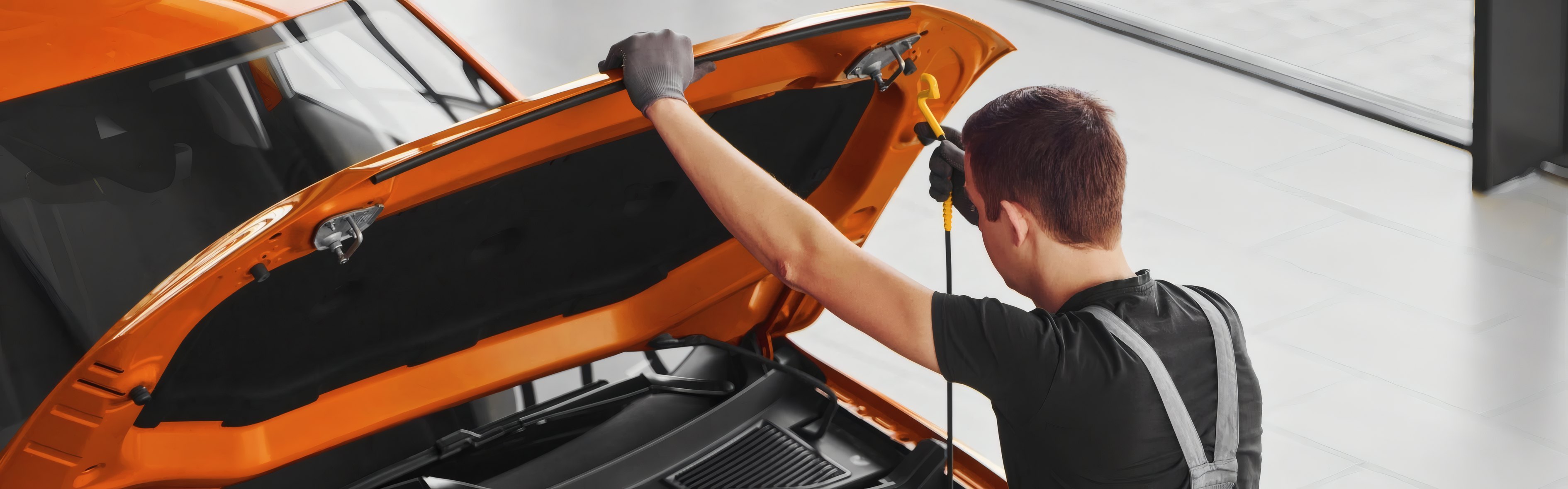 A technician under an orange bonnet
