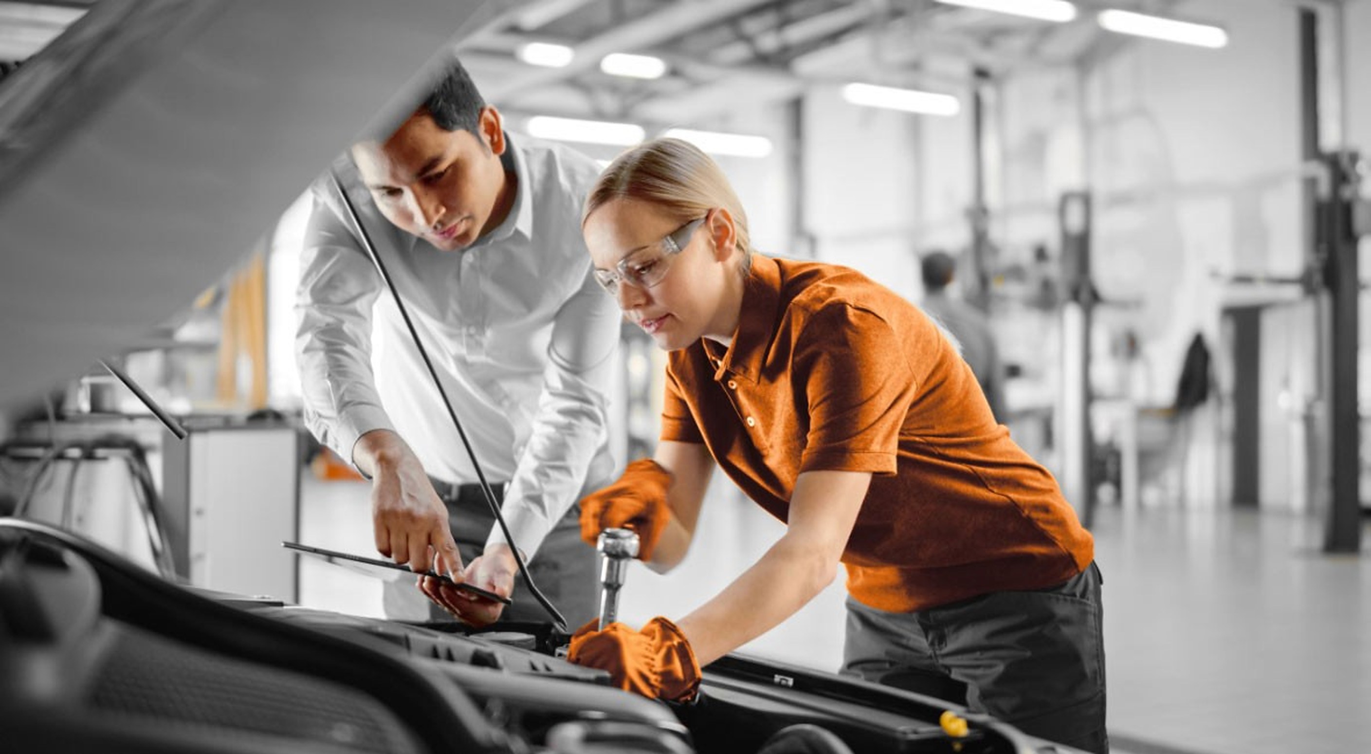 Two of the crew under a bonnet