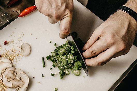 Chopping herbs on a board