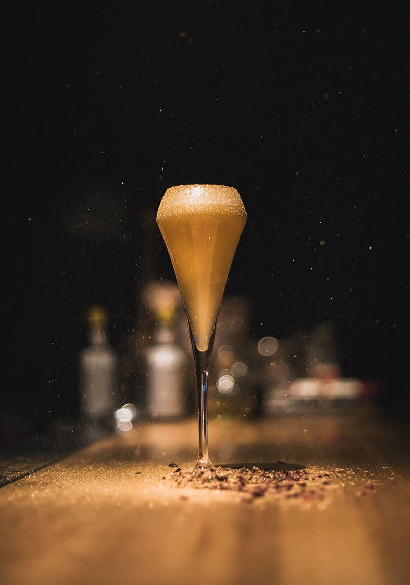 A cocktail on the bar under a low light