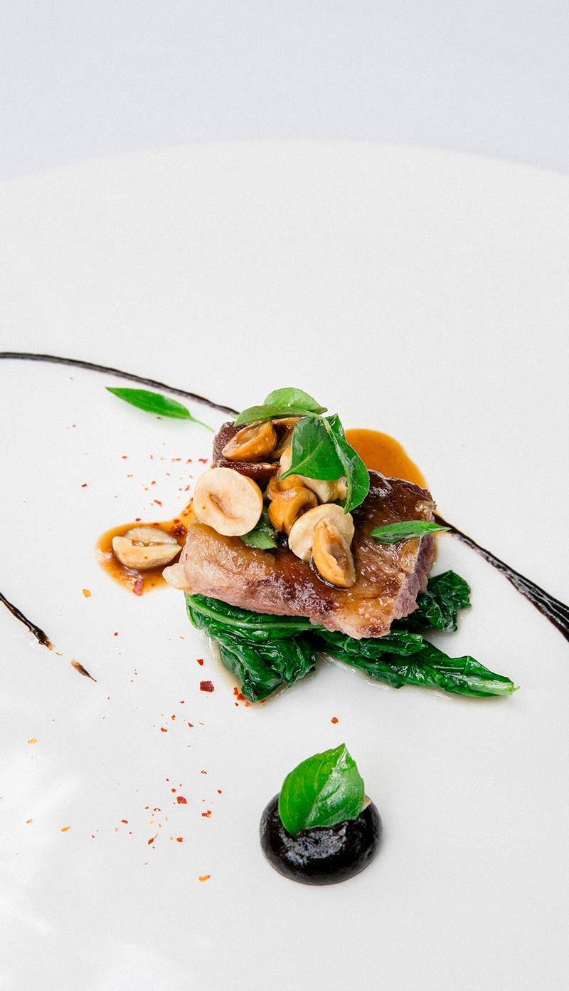 A quail dish with a sauce swoosh