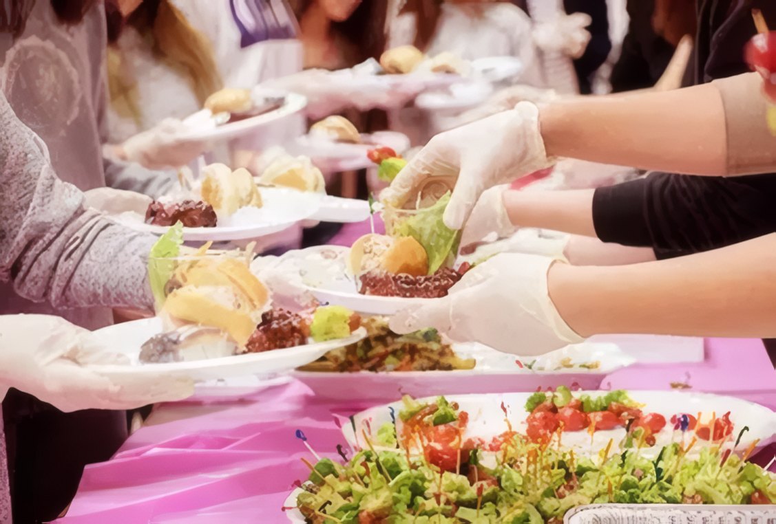 Volunteers serving food in the church hall