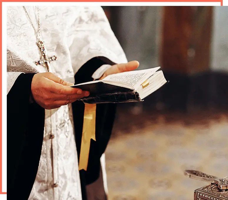 A priest holding an open prayer book