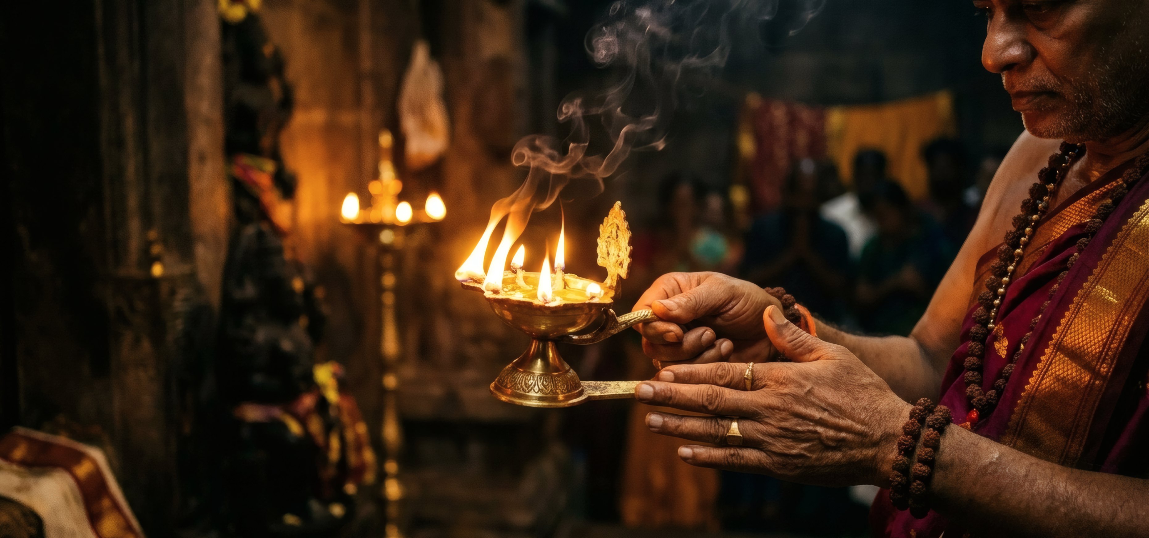 The aarti lamp raised before the deity