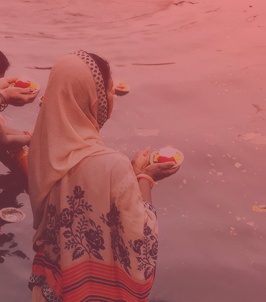 Devotee offering lamps at the river