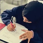 A girl drawing at a desk
