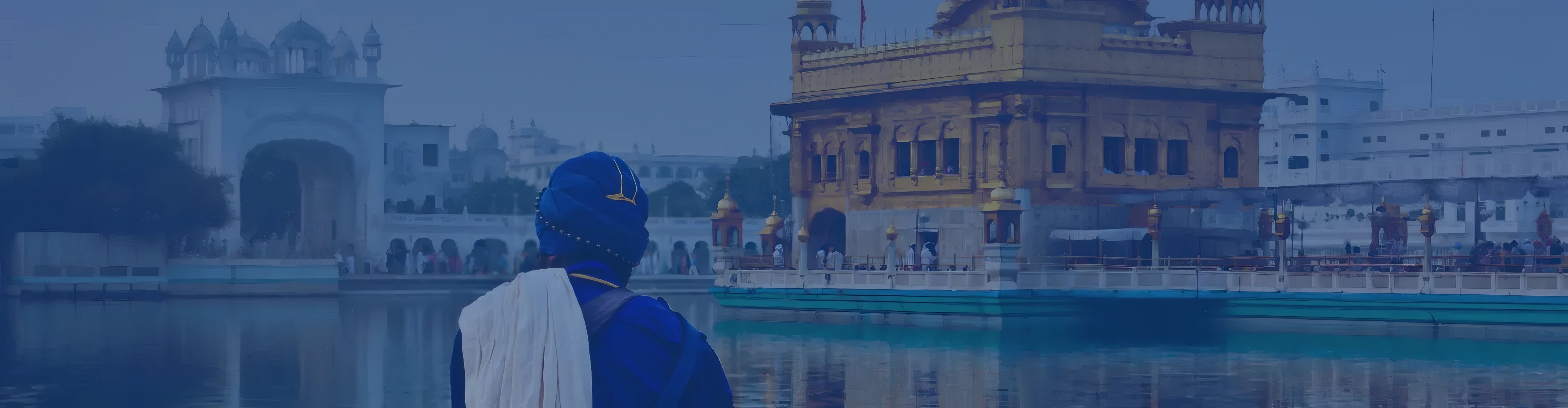 A Sikh pilgrim in a blue turban at the sarovar