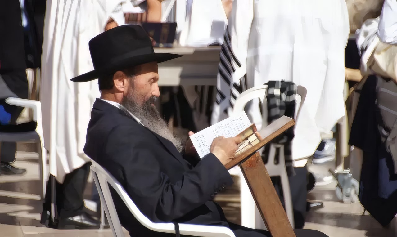 A rabbi reading at the Western Wall