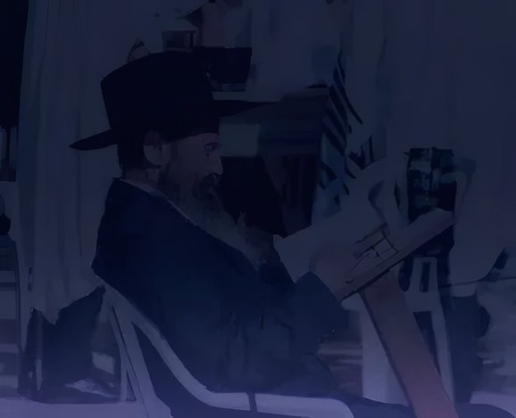 A rabbi reading at the bimah